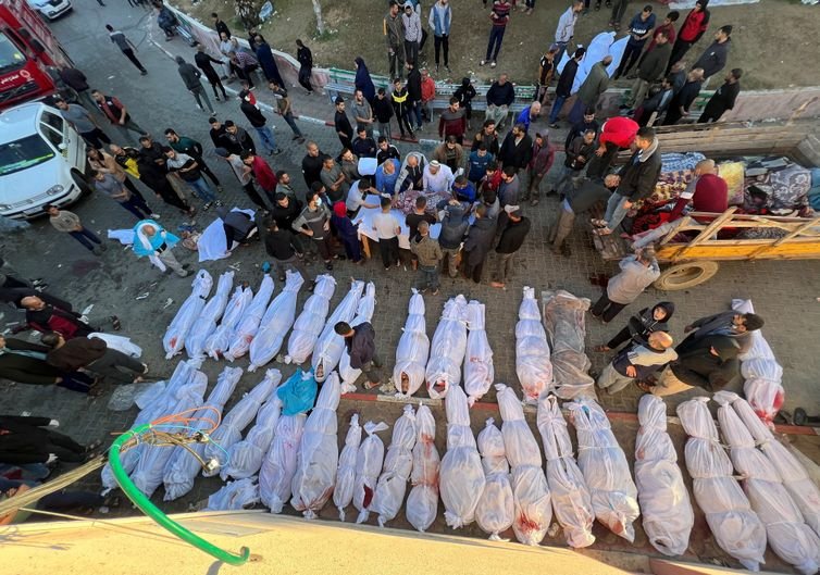SENSITIVE MATERIAL. THIS IMAGE MAY OFFEND OR DISTURB    People gather near the bodies of Palestinians killed in Israeli strikes, amid the ongoing conflict between Israel and Hamas, at the Indonesian hospital, in the northern Gaza Strip November 18, 2023. REUTERS/Fadi Alwhidi